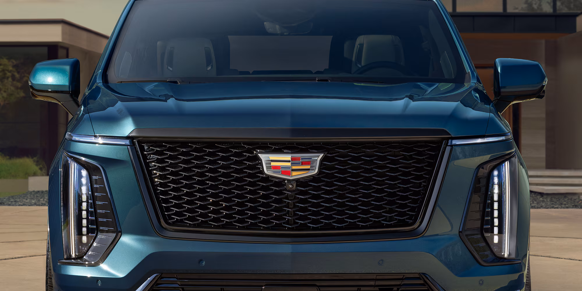 2025-vehicle-escalade-gallery-exterior-illuminated-crest.avif